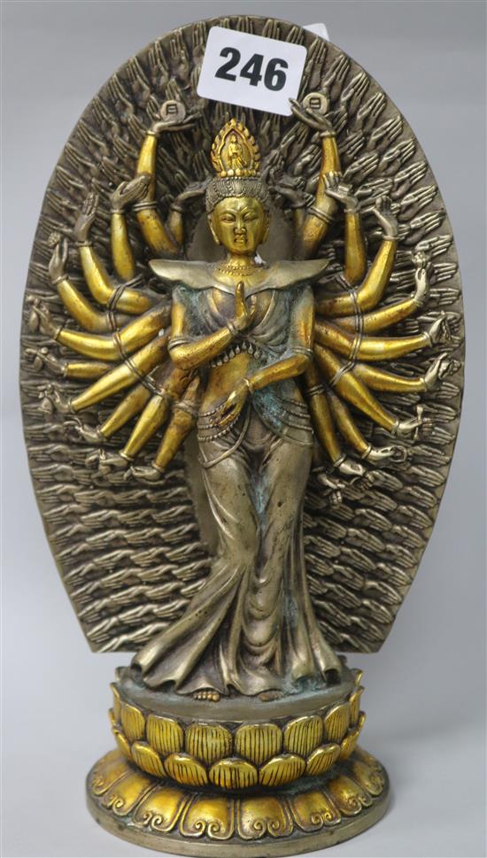 A silver and gilt metal figure of a thousand hand deity with detachable Mandaria cast hands on double lotus base H.25cm